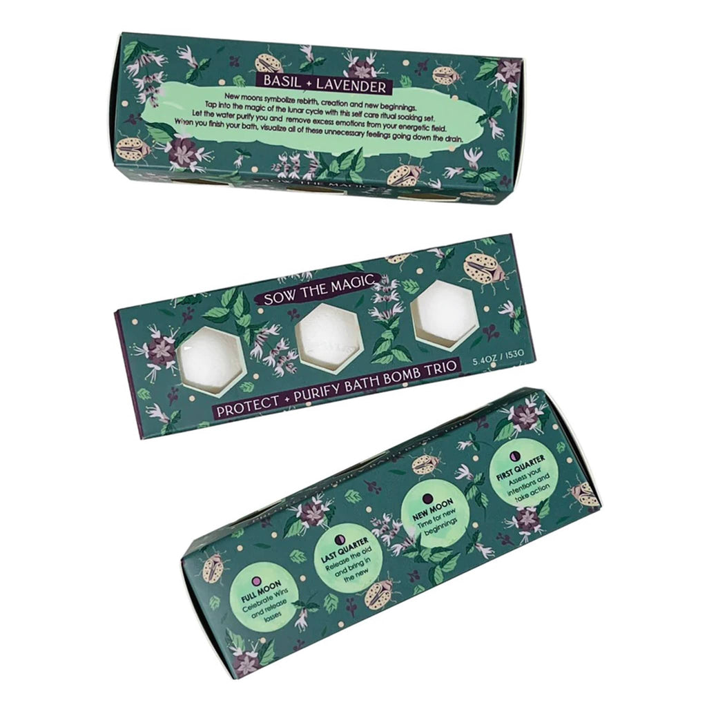Sow the Magic Moon Phase Protect and Purify Bath Bomb Trio with basil and lavender scent, packaged in a dark green illustrated box. Three boxes are shown to see different sides of the packaging.