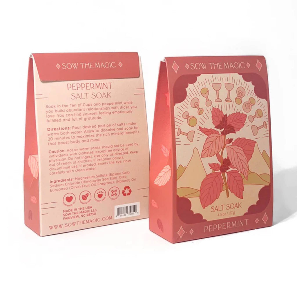 Sow the Magic Peppermint Bath Salt Soak in red box packaging with an illustration on the front that looks like a ten of cups tarot card with a peppermint leaf sprig, front and back of box are shown.
