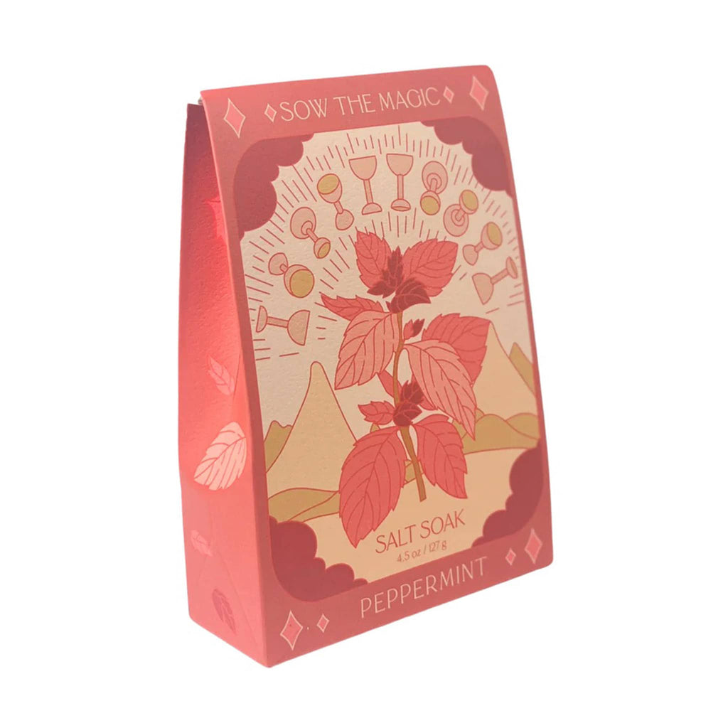 Sow the Magic Peppermint Bath Salt Soak in red box packaging with an illustration on the front that looks like a ten of cups tarot card with a peppermint leaf sprig.