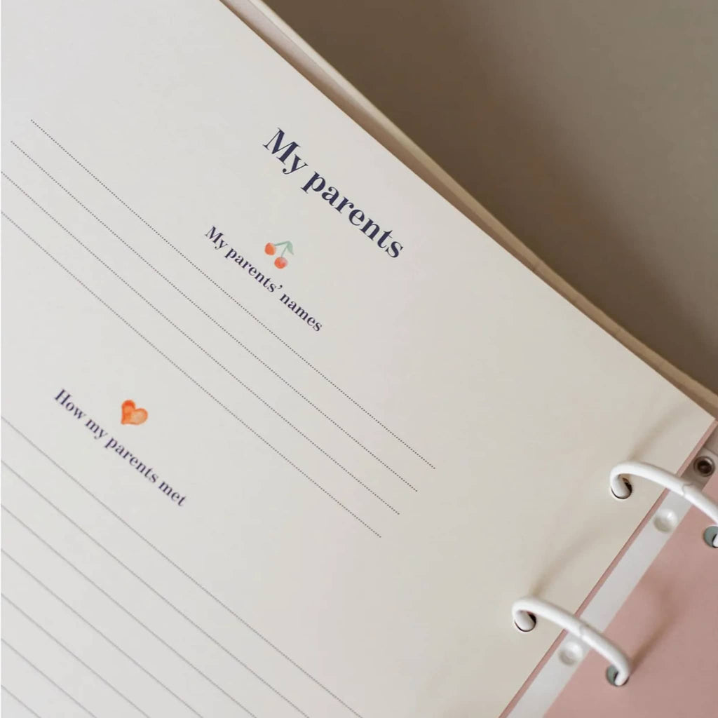 Open notebook with lined pages titled 'My parents' on a table.