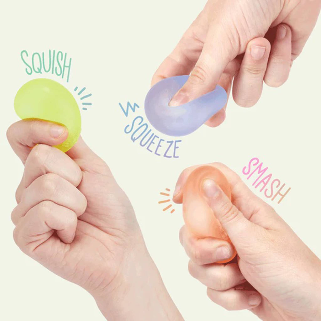 Speks Gump Mini Memory Gel Stress Balls, being squeezed by fingers.