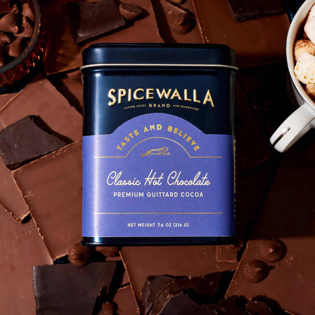 Spicewalla Classic Hot Chocolate canister surrounded by chocolate pieces.