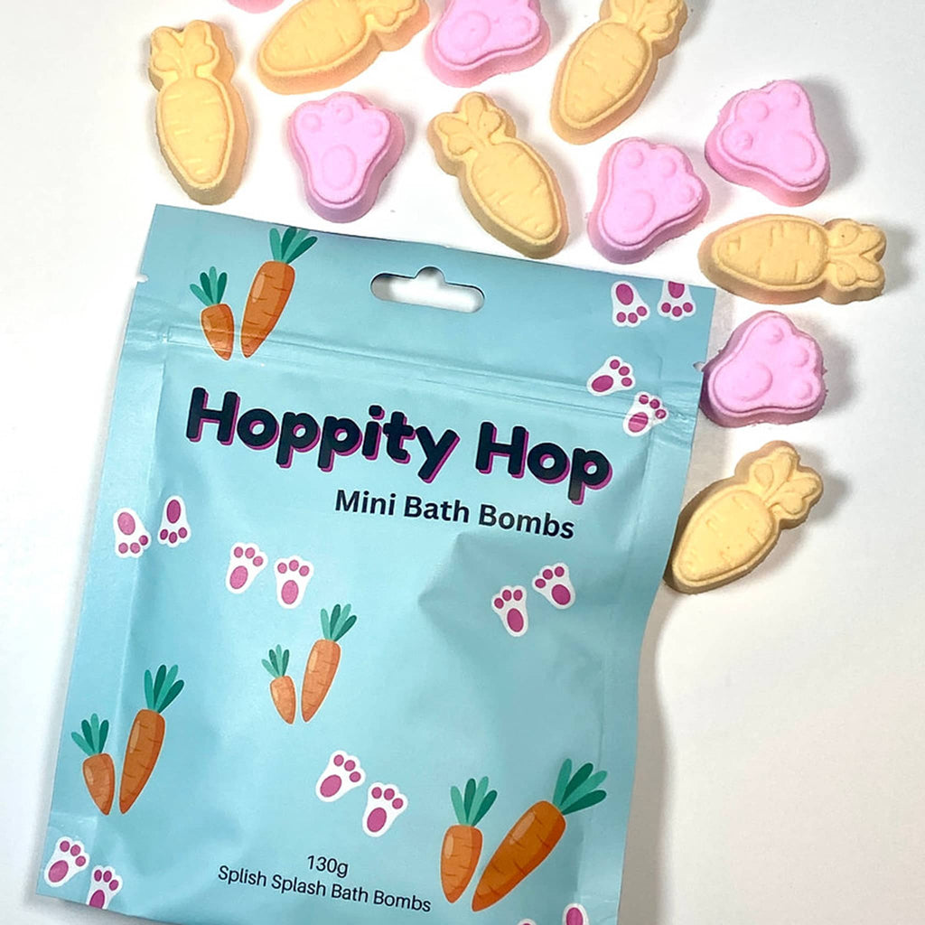 Splish Splash Hoppity Hop mini bath bombs in blue pouch packaging with yellow carrot and pink bunny paw shaped scented bath bombs spilling out.