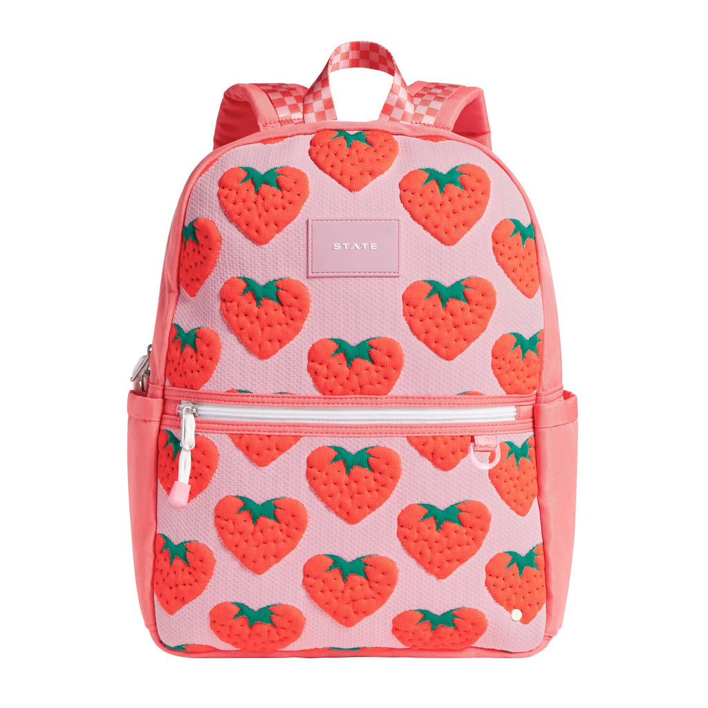 State Bags Kane Kids Backpack with red strawberries on a pink backdrop, front view.