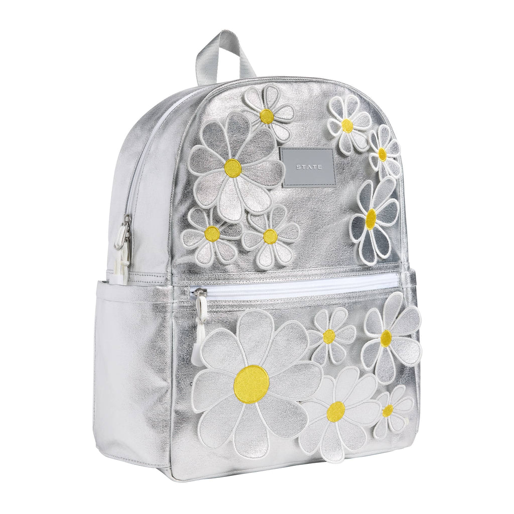 State Bags Kane Kids Travel Backpack in metallic silver 3D floral daisies, front angle view.