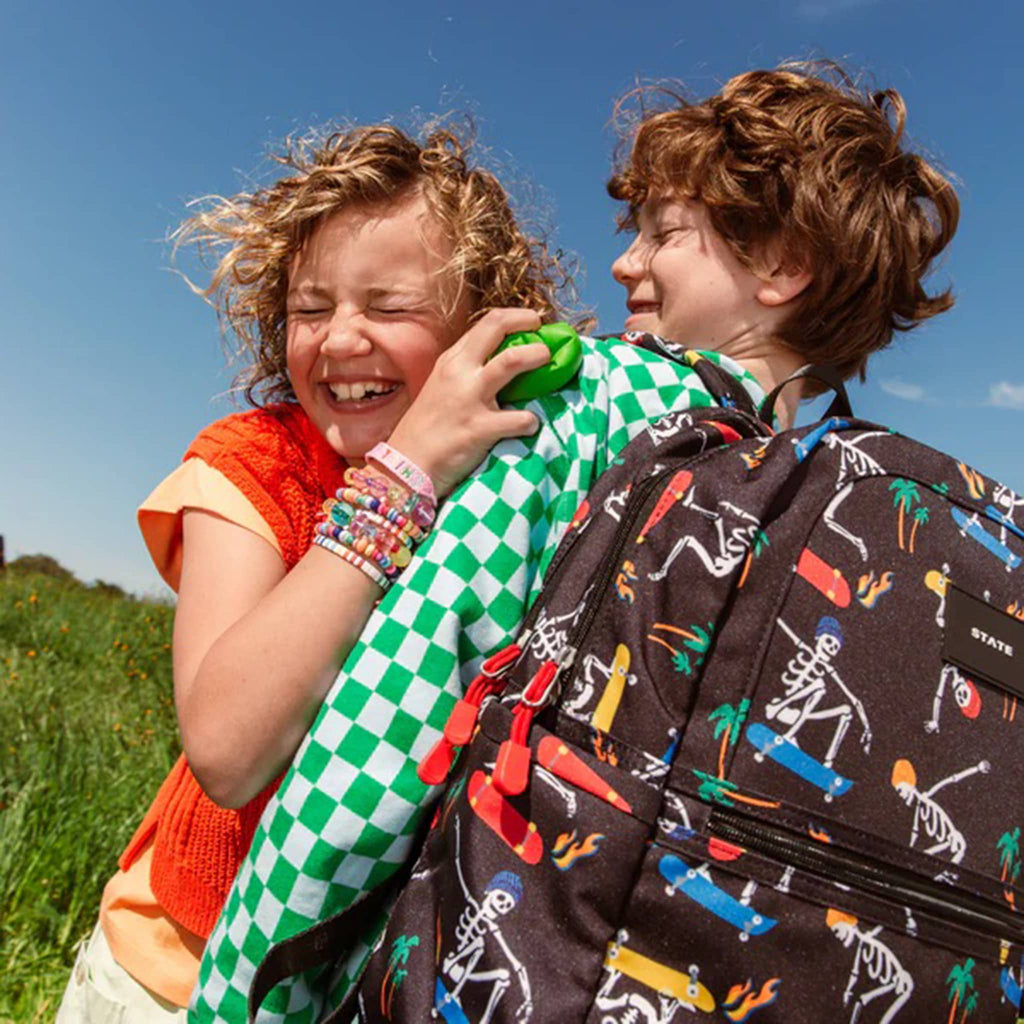 State Bags Kane Kids Double Pocket Backpack, on kids back, lifestyle.