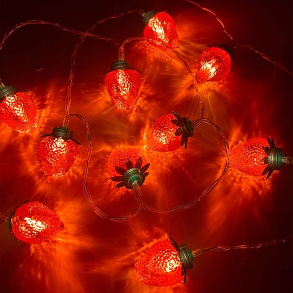 Streamline Strawberry String Lights lit up in a dark room.