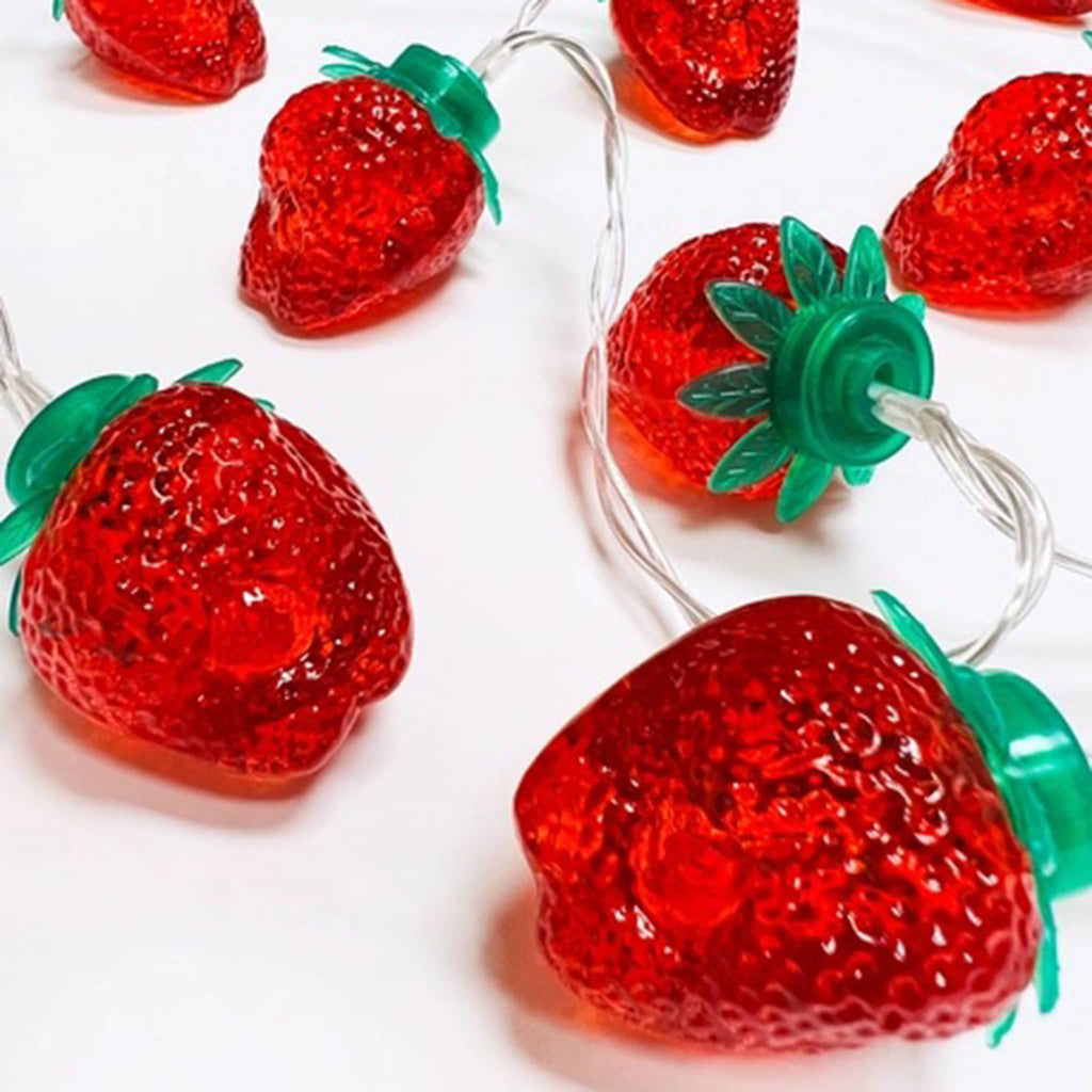 Streamline Strawberry String Lights, close-up on white background.