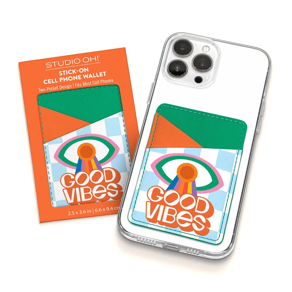 Studio Oh! Spread Good Vibes Stick-On Cell Phone Wallet with orange and green pocket design and an eye illustration with rainbow stripes and "good vibes" in orange and white lettering. Shown in packaging and attached to the back of a phone.