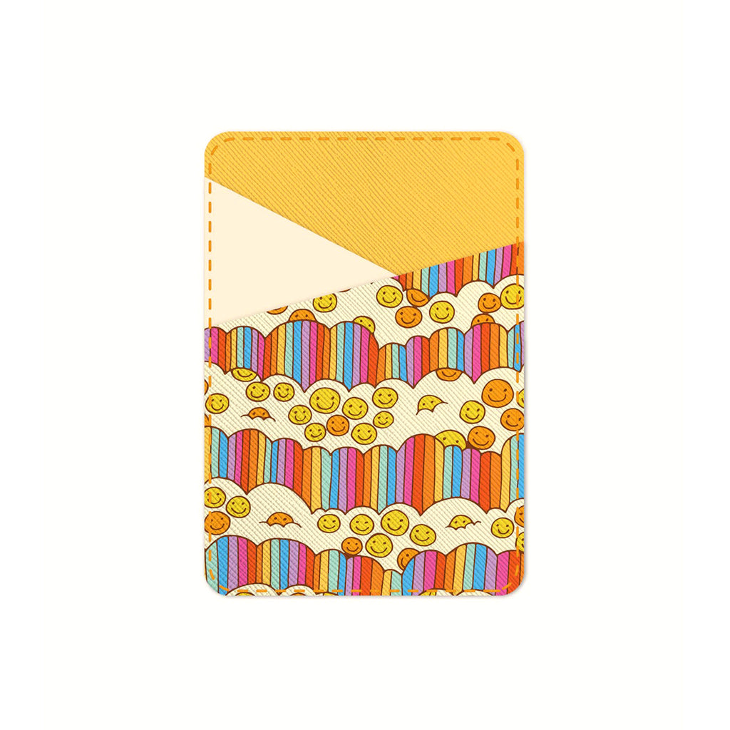 Studio Oh! Good Times Stick-On Cell Phone Wallet with with pale and golden yellow pocket design, rainbow striped clouds and smiley faces. 