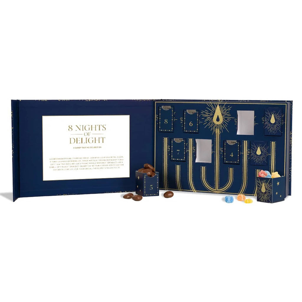 Sugarfina 8 Nights of Delight candy tasting collection, box open with a couple of candy drawers removed, on a white background.