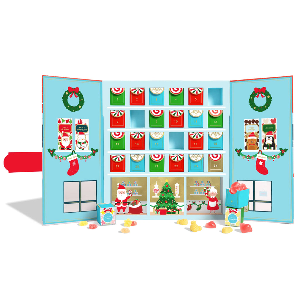 Sugarfina 2023 Santa's Candy Shop Advent Calendar, open to see inside with numbered candy drawers and various festive characters.