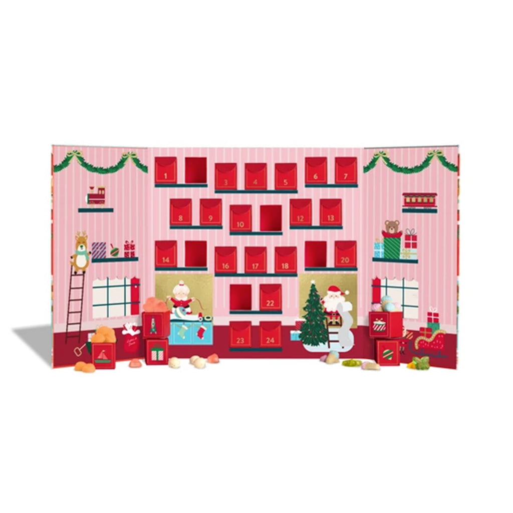 Advent calendar with Christmas-themed design and candy pieces in front, on a white background.