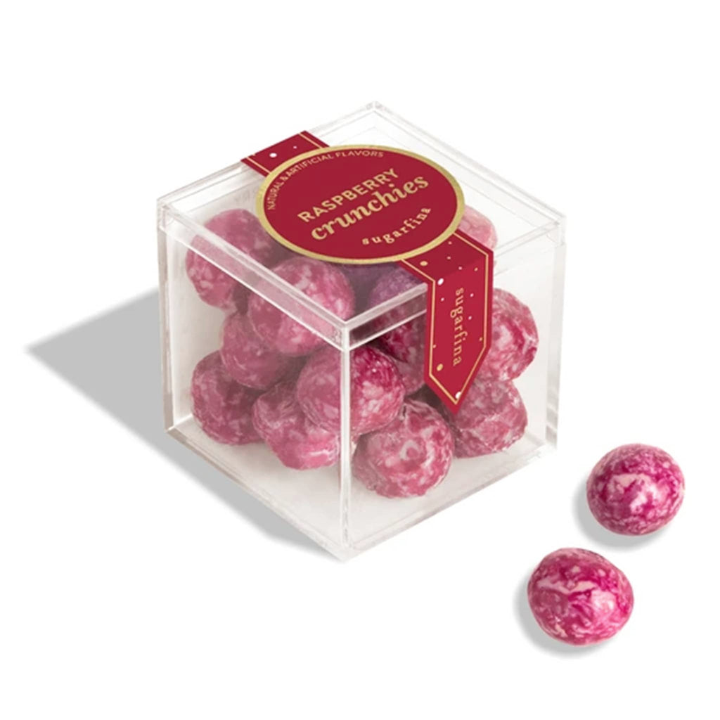 Pink raspberry crunchies candy in a clear box with a red label on a white background.
