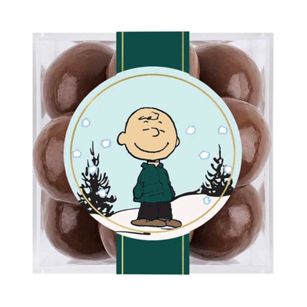 Pack of chocolate balls with a Charlie Brown snow globe design on the packaging.