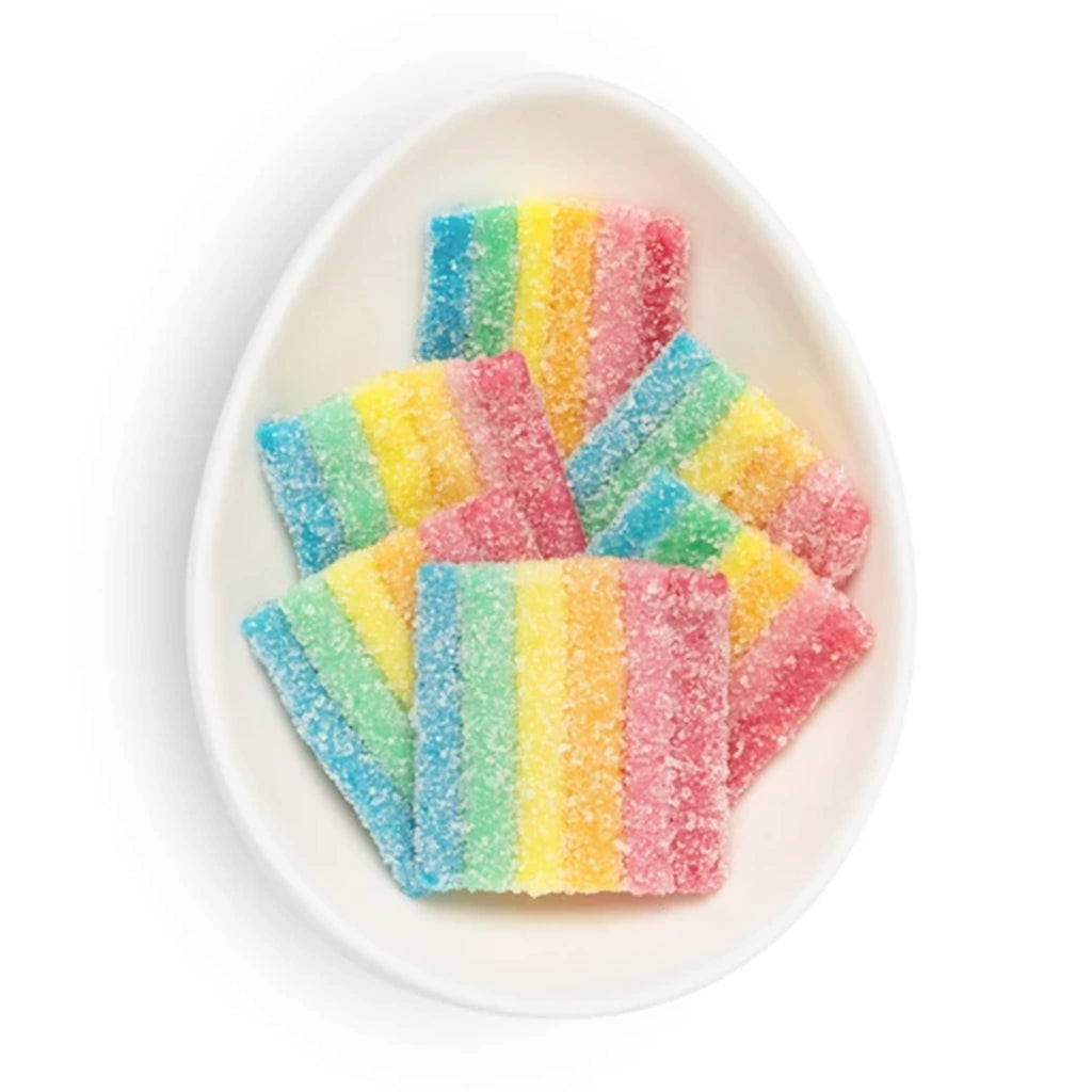 Colorful striped candies on a white plate.