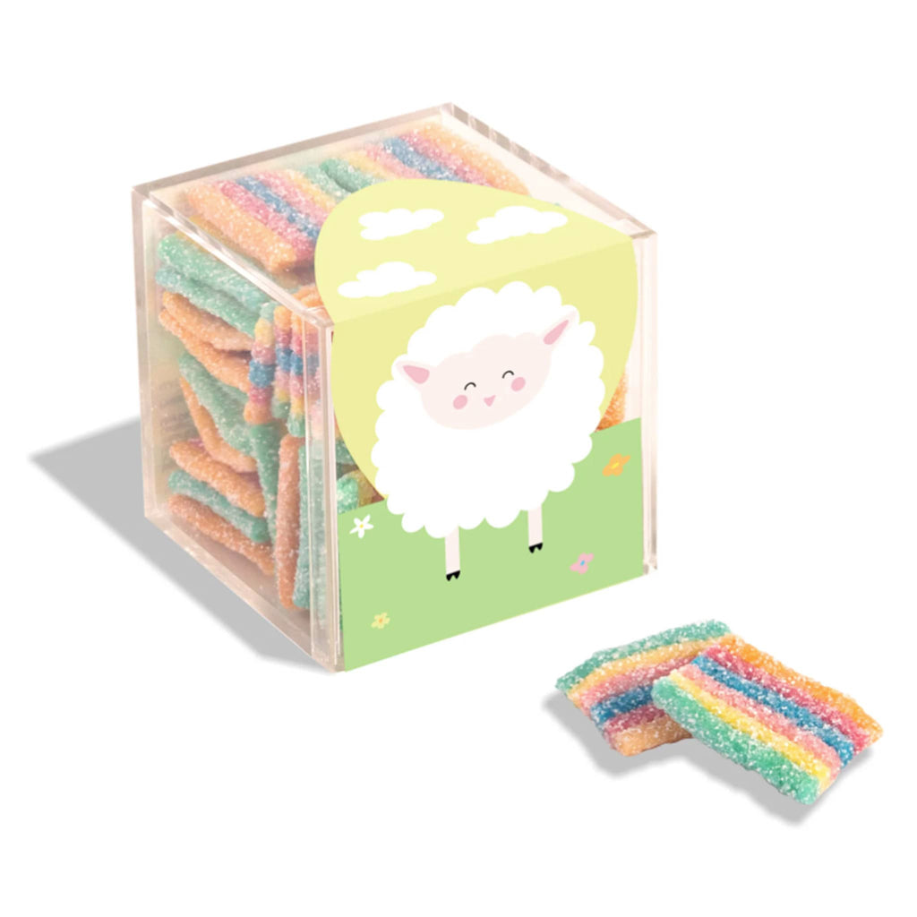 Sugarfina Sour Rainbows gummy candy in small acrylic candy cube packaging with lamb illustration, front angle.