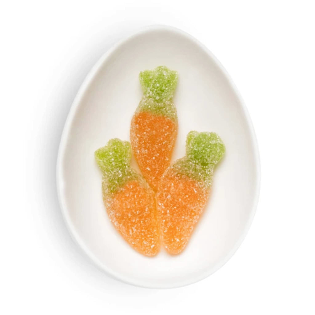 Sugarfina Easter 2025 Baby Carrots bunny gummy candy in white oval dish.