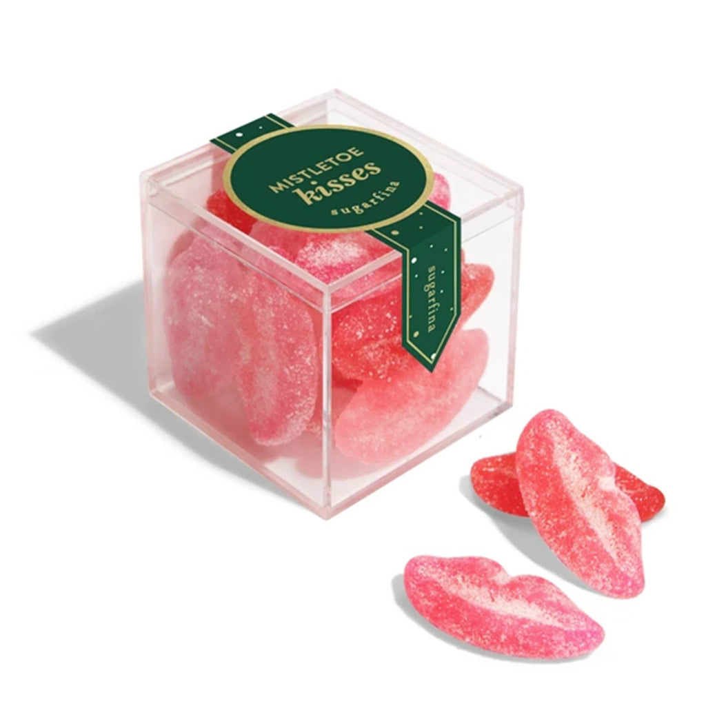 Pink gummy candy shaped like lips in a clear box with a green label on a white background.