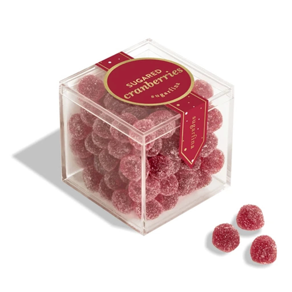 Clear cube container filled with sugared cranberries on a white background.