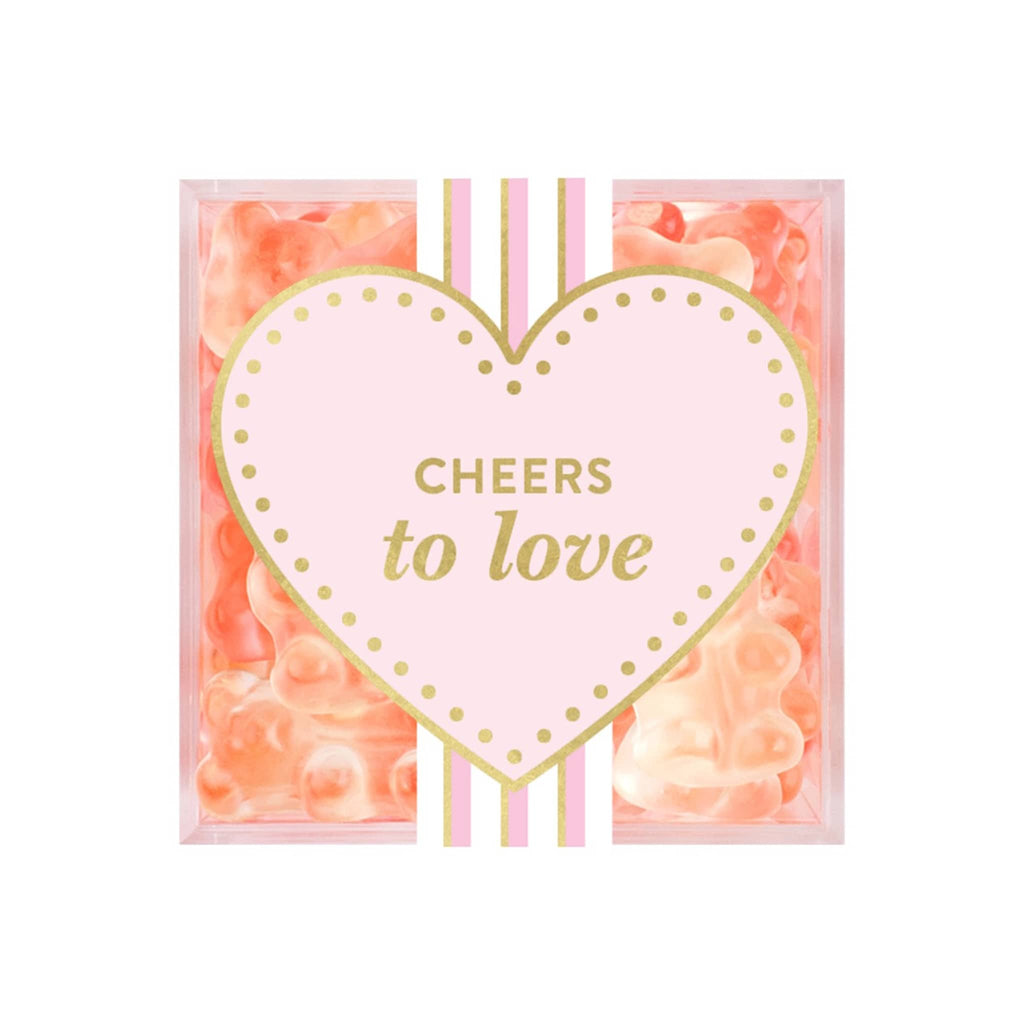 Sugarfina champagne bears in clear acrylic candy cube packaging, top view with pink heart sticker that says "cheers to love."