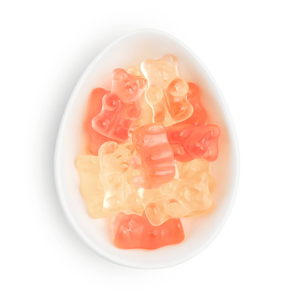 Sugarfina champagne bears in white oval dish.