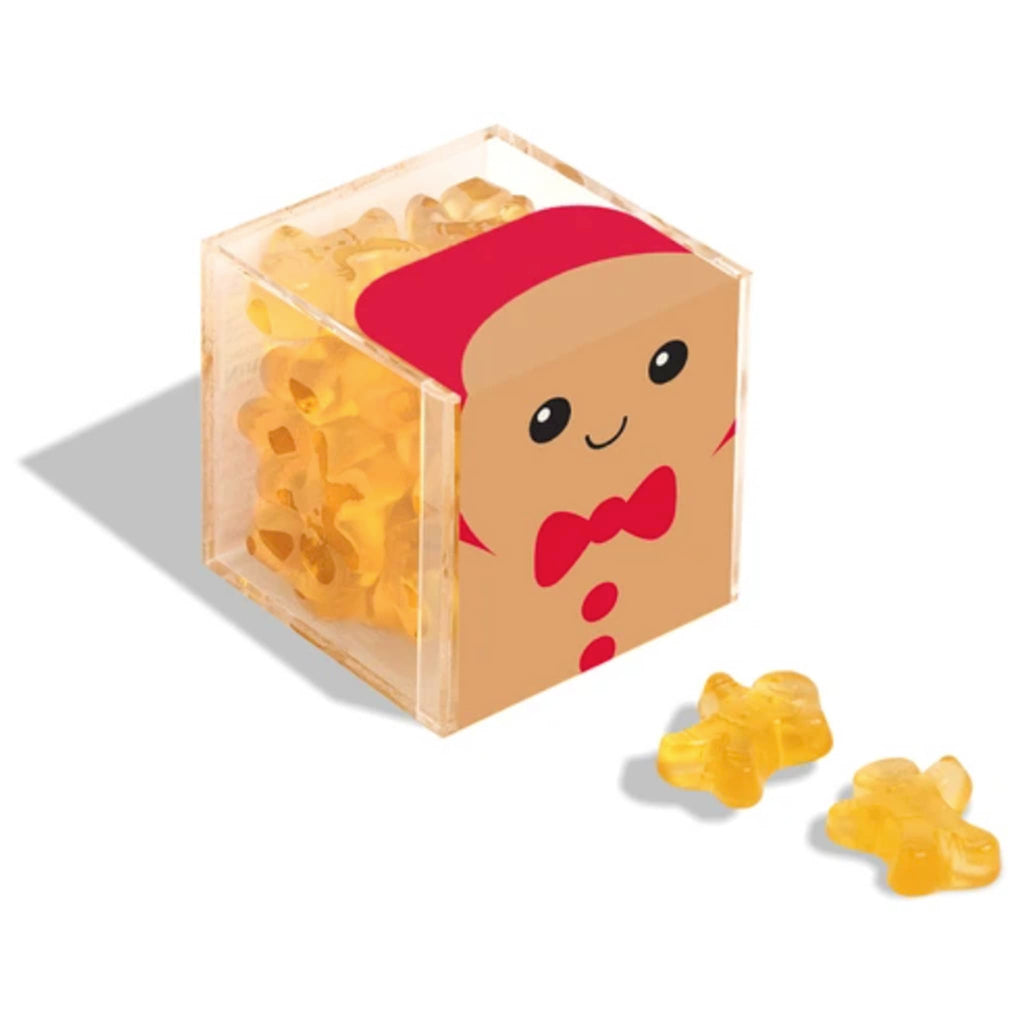 Sugarfina Holiday 2024 Santa Gingerbread Man Cuties gummy candy in gingerbread man candy cube packaging with candies in front.