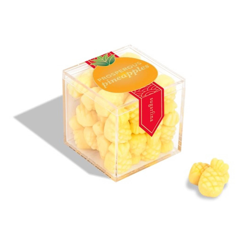 Sugarfina 2025 Lunary New Year Prosperous Pineapples gummy candy in clear acrylic candy cube packaging, front angle view.