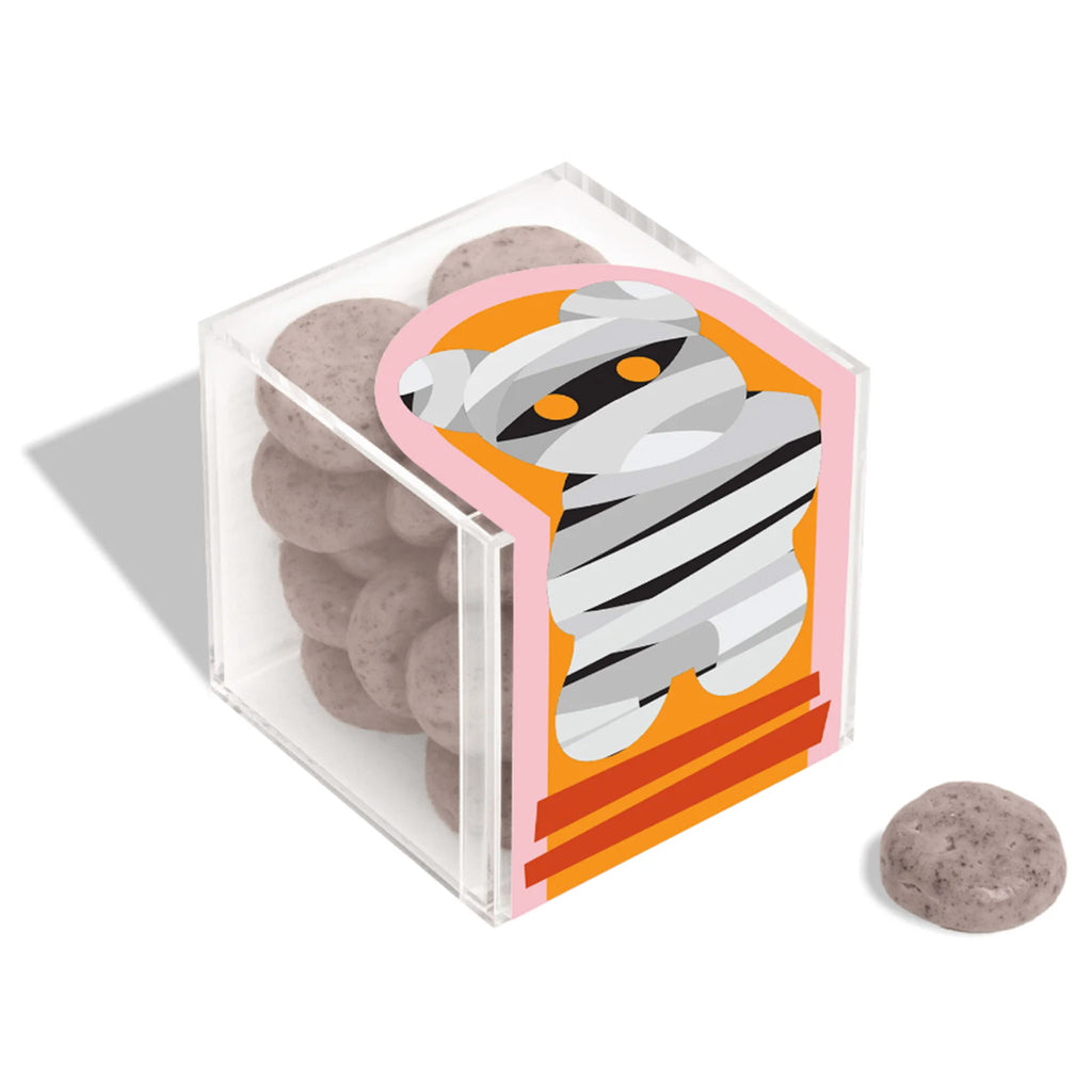 Sugarfina 2023 Mummy Graveyard Cookies in acrylic candy cube, front and top angle view with a piece in front.