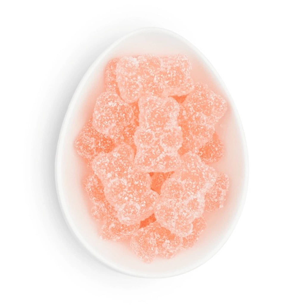 Sugarfina sparkling rose bears gummy candy in white oval dish.