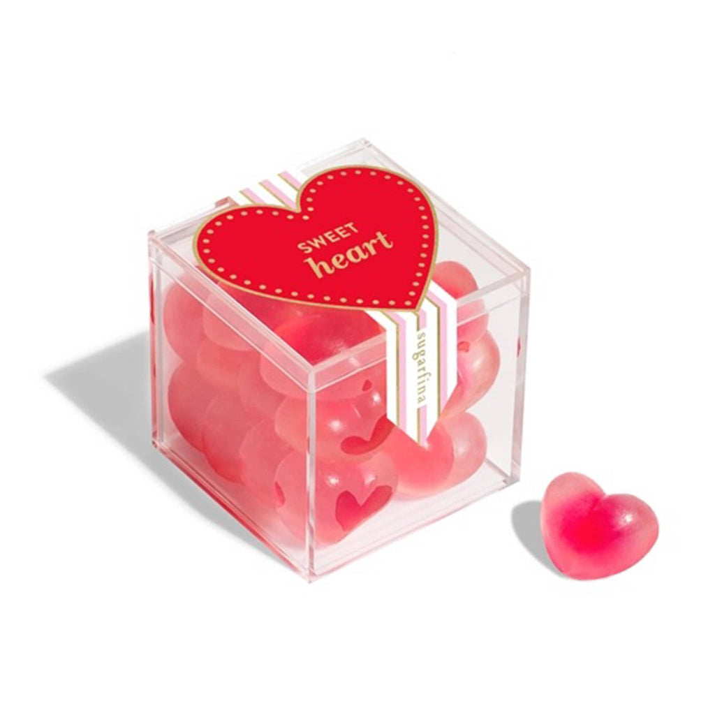 Sugarfina strawberry hearts gummy candy in clear acrylic candy cube packaging, front angle view.