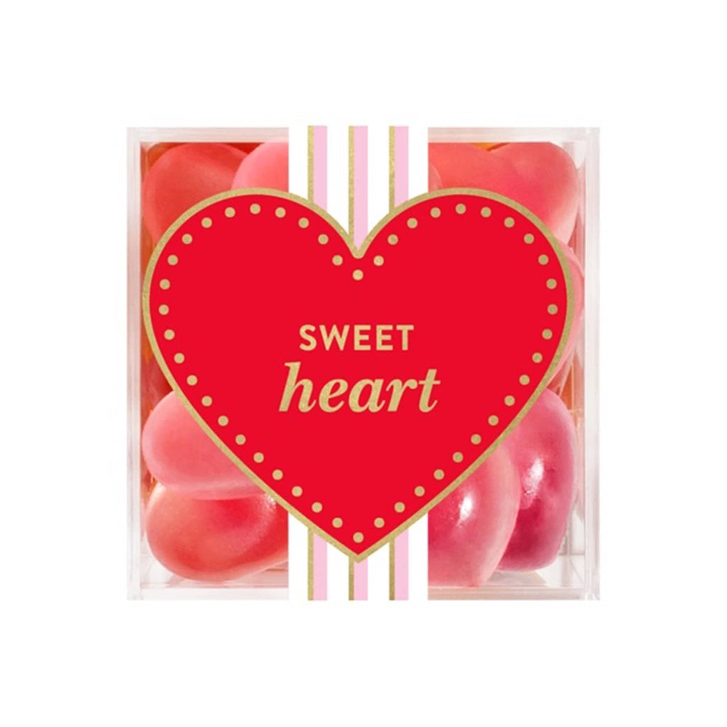 Sugarfina strawberry hearts gummy candy in clear acrylic candy cube packaging, top view with red heart that says "sweet heart" in gold foil lettering.