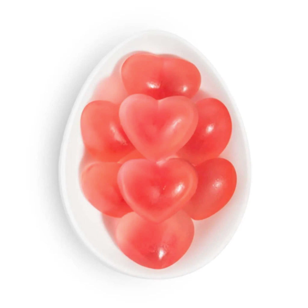 Sugarfina strawberry hearts gummy candy in white oval dish.