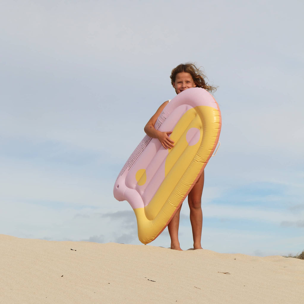 Sunnylife Summer Sherbet Kids Inflatable Body Boogie Board, child carrying it on a beach.