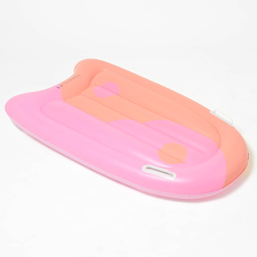 Sunnylife Summer Sherbet Kids Inflatable Body Boogie Board, top view of inflated board with pink and orange yin yang design and white handles.