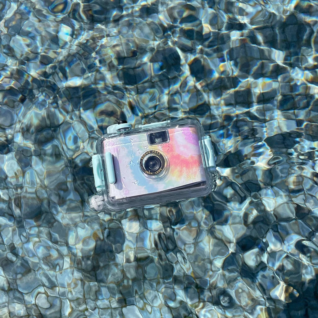 Sunnylife Rainbow Tie Dye 35mm waterproof underwater camera in a swimming pool.