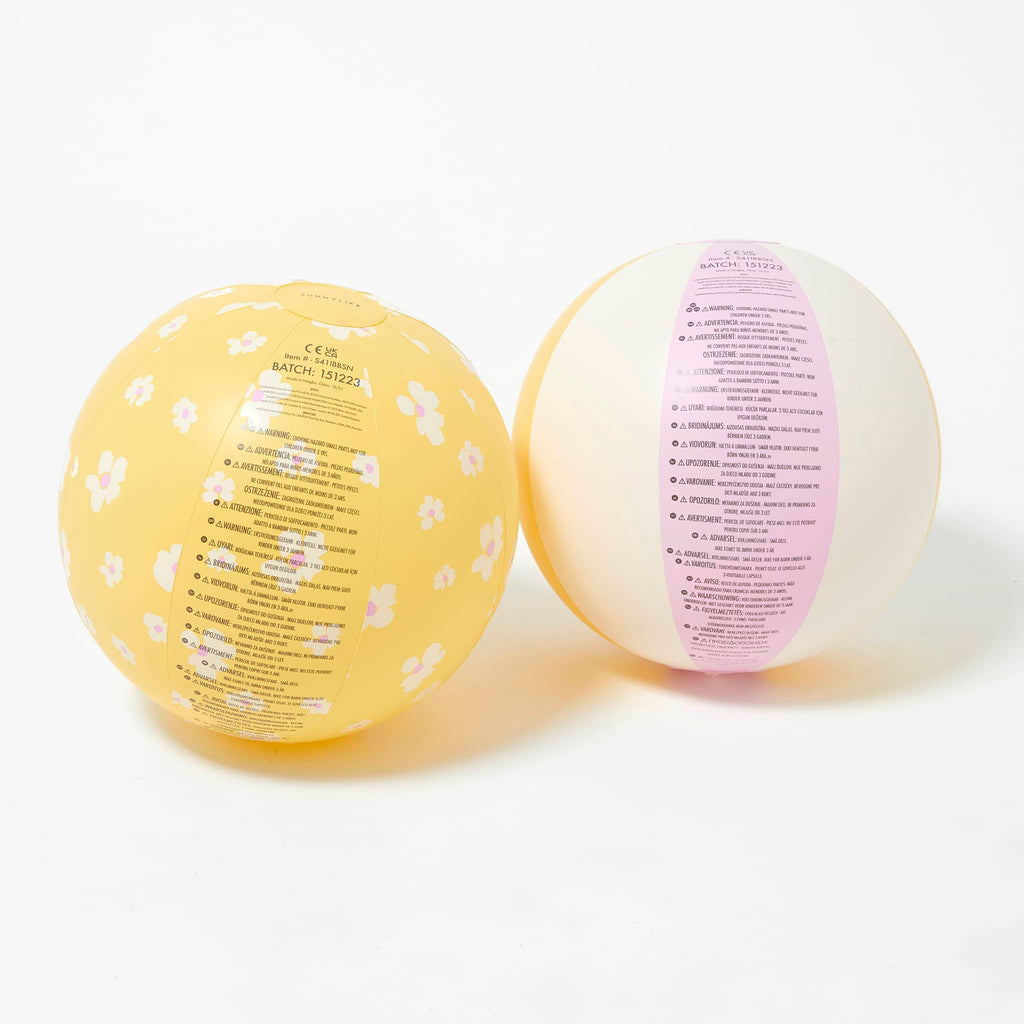Sunnylife Princess Swan Inflatable Beach Balls, set of 2, one is pale orange with white flowers, the other is pink, white and orange striped, with safety warnings.