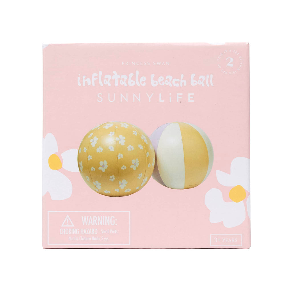 Sunnylife Princess Swan Inflatable Beach Balls, set of 2, one is pale orange with white flowers, the other is pink, white and orange striped, in pink box packaging, front view.