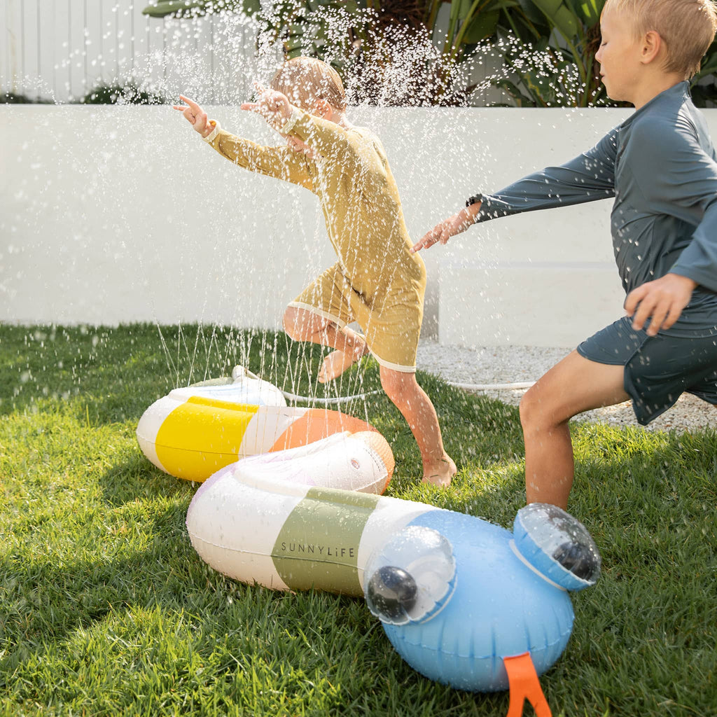 Sunnylife Into the Wild Inflatable Snake Water Sprinkler, in use with 2 kids in a backyard.