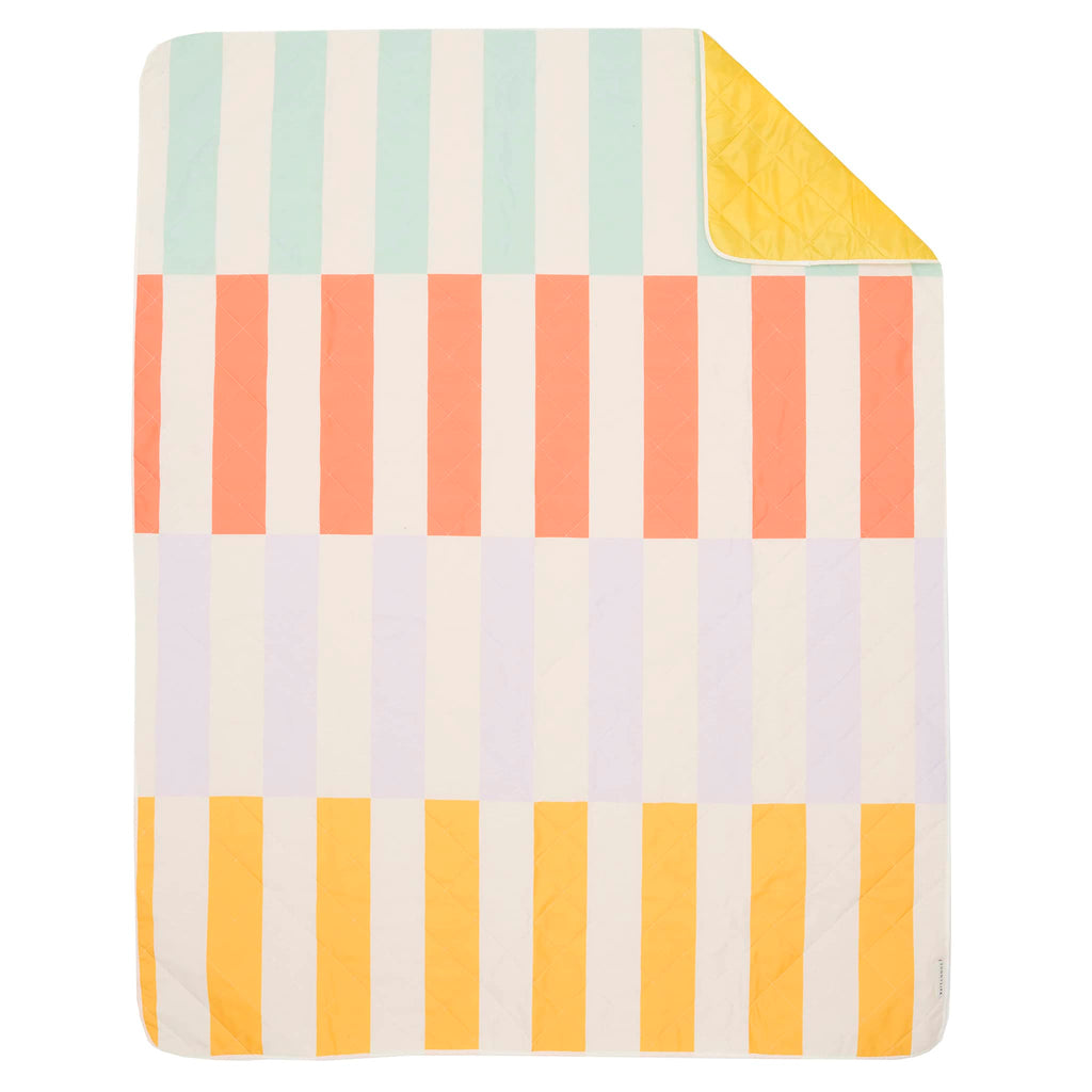 Sunnylife Beach and Picnic Blanket in Rio Sun with colorful stripes, flat front view with corner flipped back to see yellow backing.