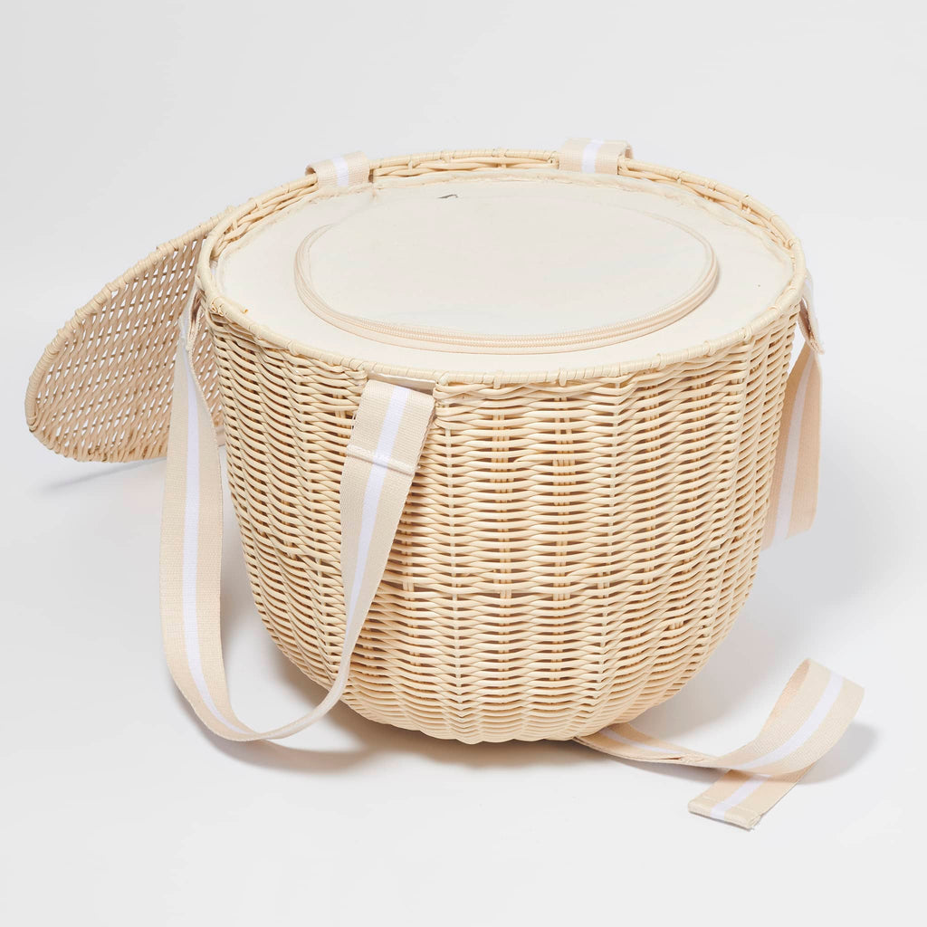 Sunnylife Round Plastic Rattan Insulated Picnic Cooler Basket in Le Weekend with natural and white webbed straps, side view with rattan lid open.