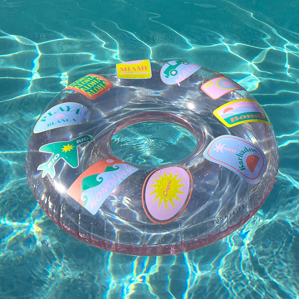 Sunnylife Inflatable Tube Pool Ring in Beach Hopper pink, floating in a pool.