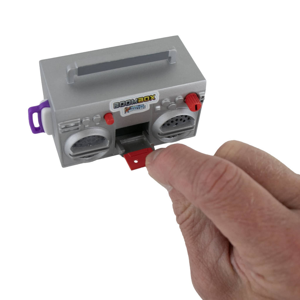 Toy boombox held by a hand on a white background.