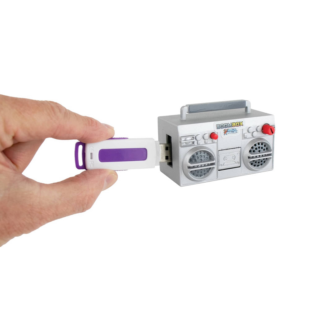 Toy boombox with USB port held by a hand on a white background.