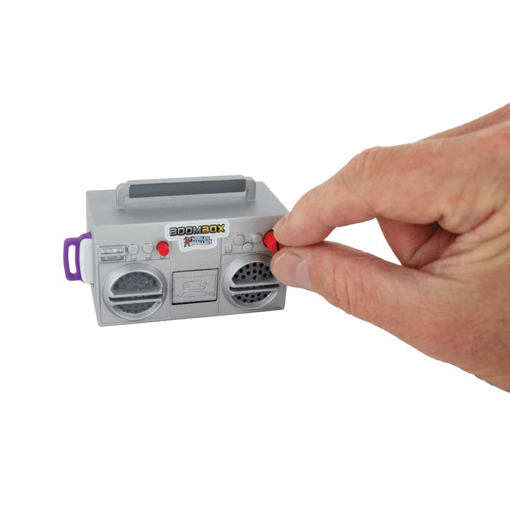 Hand pressing a button on a toy boombox with a white background.