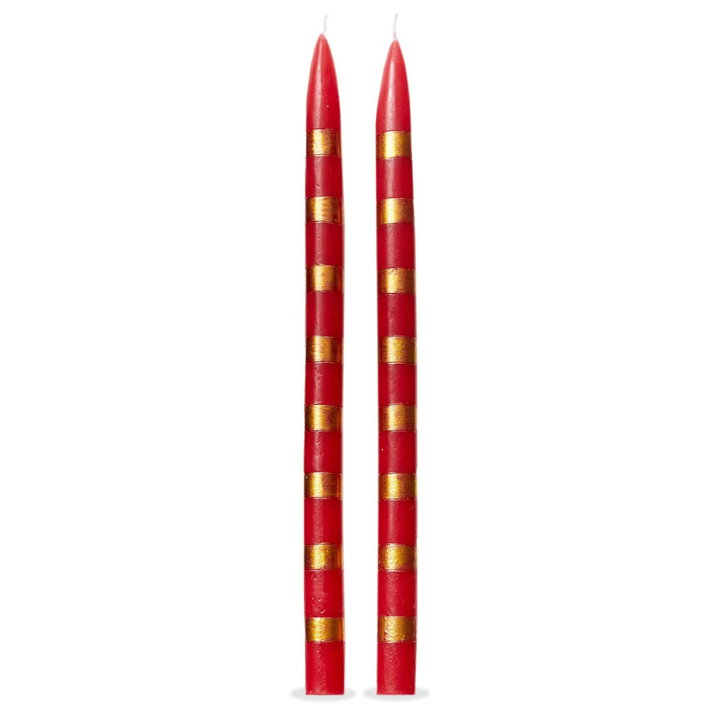 Two red taper candles with gold stripes on a white background.