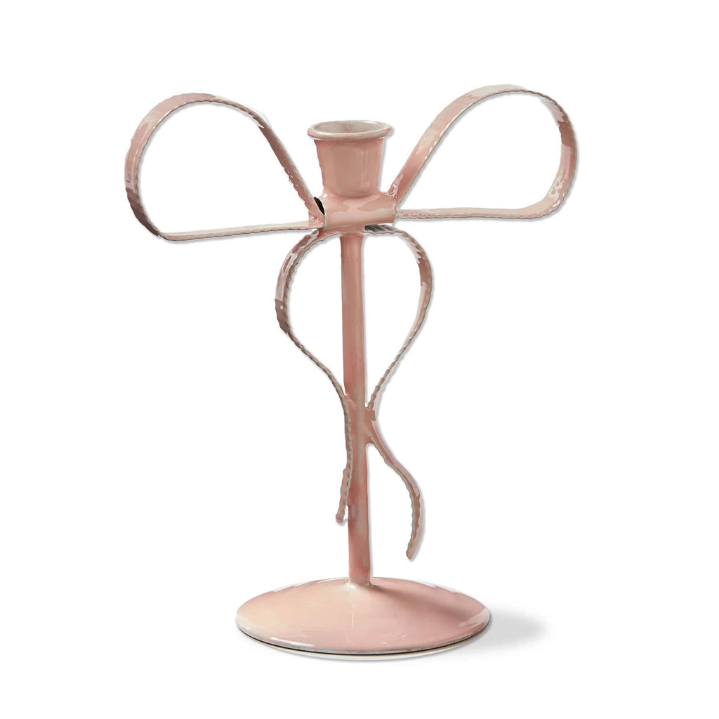 Pink candle holder shaped like a bow on a white background.