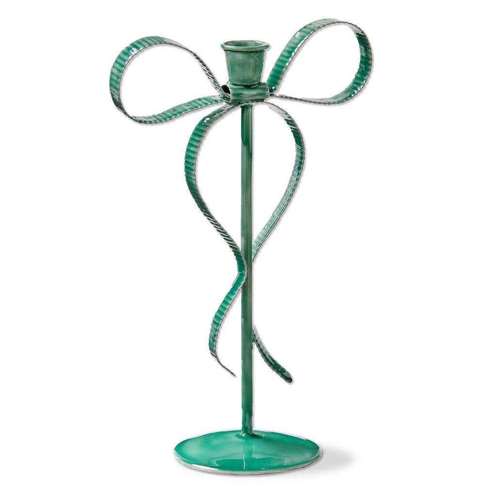 Decorative green metal candle holder shaped like a bow on a white background.