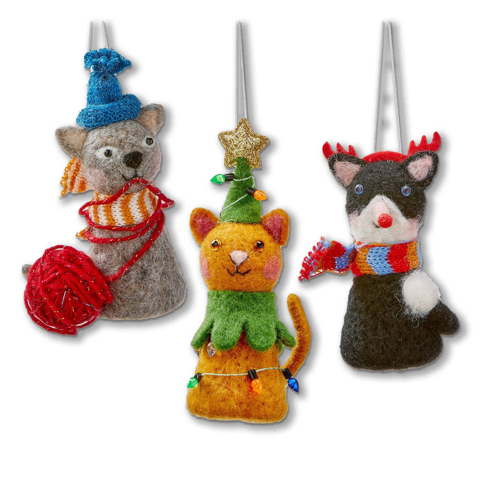 Three festive felt cat ornaments on a white background.