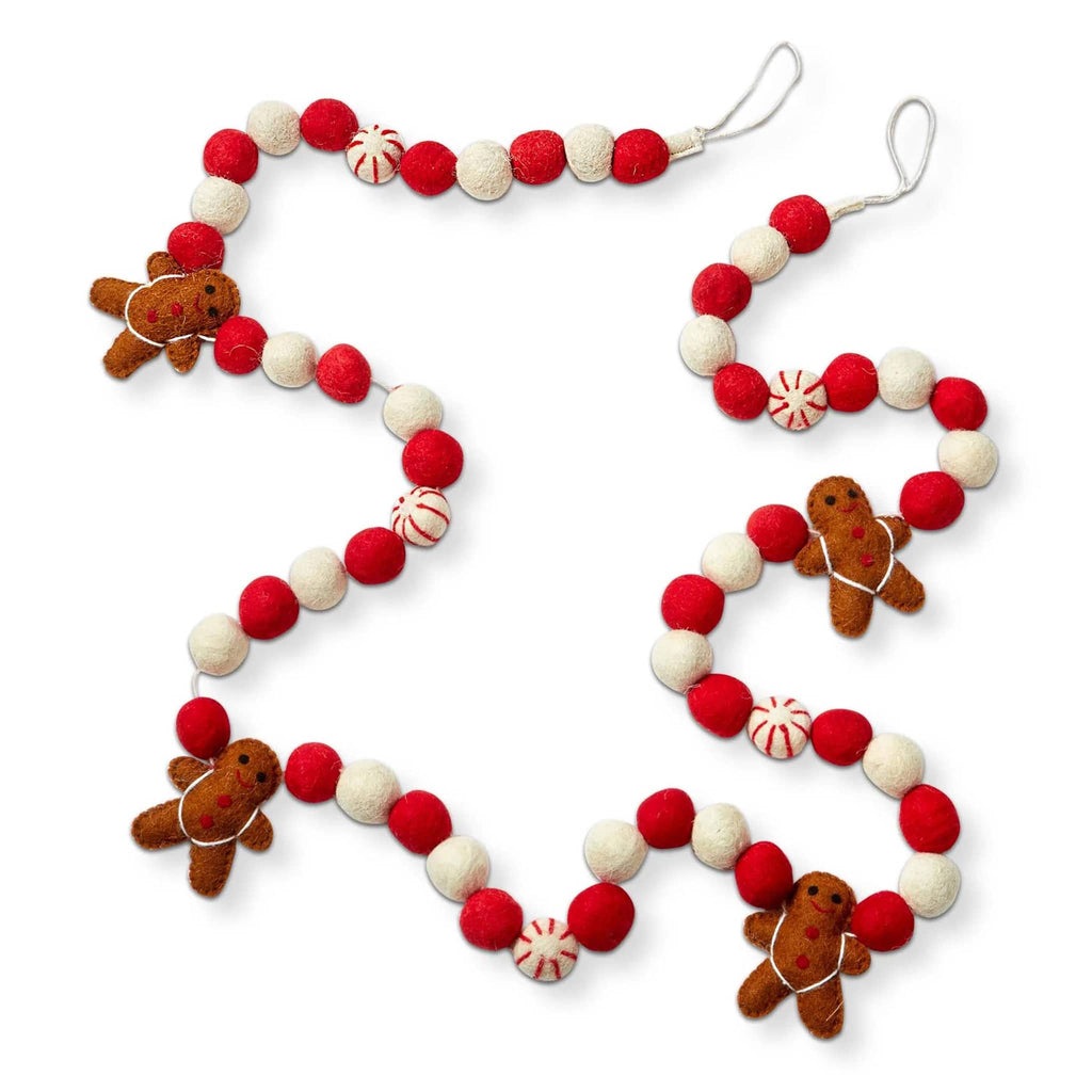 Decorative garland with gingerbread men and red and white wool felt balls with hanging loops at both ends, on a white background.
